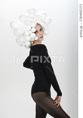 Fashion model wearing white bubble headpiece and black leotard Fashion model wearing white bubble headpiece and black leotard 136468153