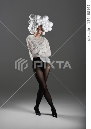 Woman posing wearing avant-garde bubble headpiece fashion 136468161
