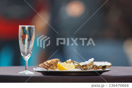 Elegant Oyster Plate With Lemon Slices And Champagne Glass For Fine Dining And Celebration 136470668
