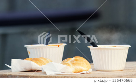 Steaming hot soup with bread roll at winter food market Steaming hot soup with bread roll at winter food market 136470669