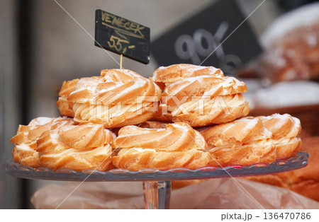 Delicious Czech Swirled Cream Pastries on Glass Cake Stand Delicious Czech Swirled Cream Pastries on Glass Cake Stand 136470786