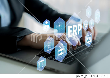 Business Professional Using Laptop with ERP Icons Displayed in Front of Hands for Technology, Management, and Digital Transformation Concept Development Quark 136470942