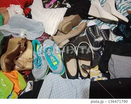 Pile of assorted used shoes and clothes. Pile of assorted used shoes and clothes. 136471790
