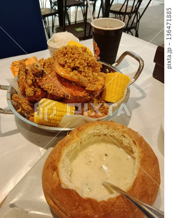 Crispy fried seafood with corn and bread bowl soup. 136471885