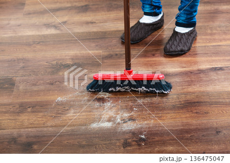 Cleaning woman sweeping wooden floor Cleaning woman sweeping wooden floor 136475047