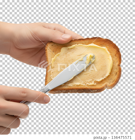 Hands spreading creamy butter over a warm, golden brown slice of toast, isolated. Perfect for breakfast concepts and comfort food Hands spreading creamy butter over a warm, golden brown slice of toast, isolated. Perfect for breakfast concepts and comfort food 136475571