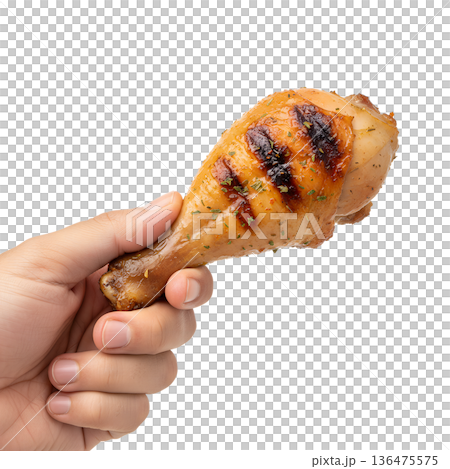 Hand holding grilled, golden-brown chicken drumstick with crispy skin, isolated. Ideal for barbecue, comfort food, and summer cookouts Hand holding grilled, golden-brown chicken drumstick with crispy skin, isolated. Ideal for barbecue, comfort food, and summer cookouts 136475575