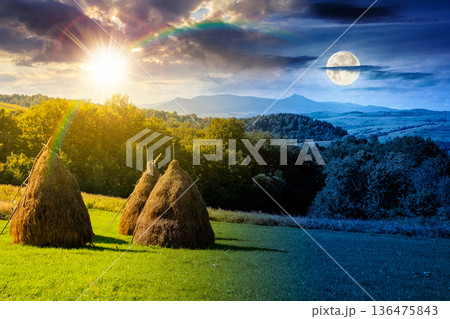 rural landscape in mountains. time change concept. grassy rolling hill and peak in early autumn with sun and moon. alpine countryside pasture. uncertainty, trust issues, and difficult relationship 136475843
