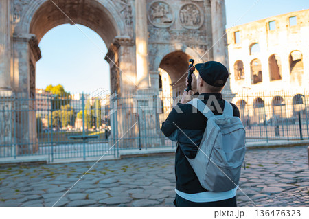 Tourist Taking Photos of Ancient Roman Arch in Rome, Italy 136476323