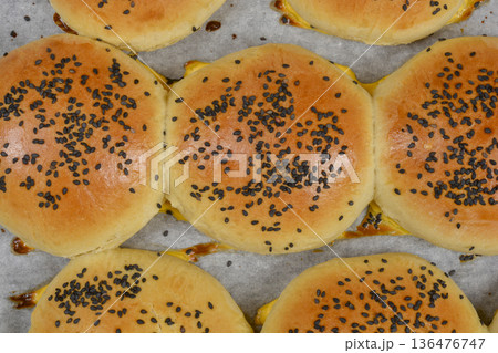 Top view of freshly baked buns with black sesame seeds Top view of freshly baked buns with black sesame seeds 136476747