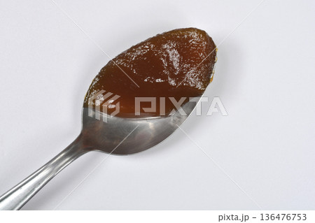 Spoonful of apricot jam on white background Spoonful of apricot jam on white background 136476753