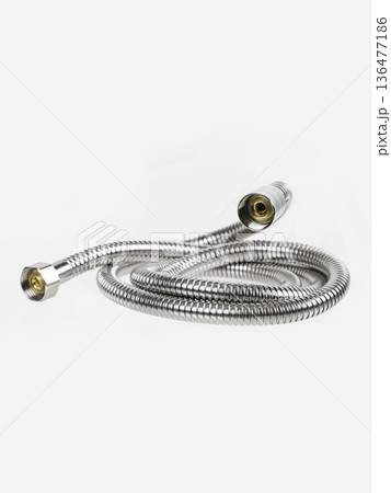 Shower hose is insulated on a white background. The hose is flexible, metal, chrome-plated. Shower hose is insulated on a white background. The hose is flexible, metal, chrome-plated. 136477186