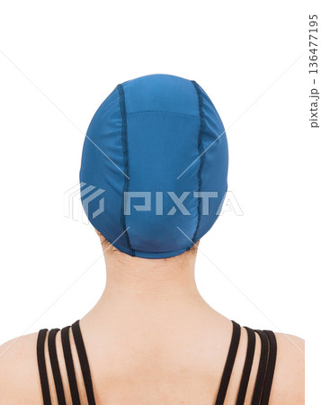 Beautiful athletic girl advertises a swimming cap. Model on a white background. Blue color. 136477195
