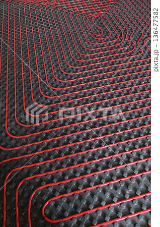 Tubes of radiant underfloor heating installation Tubes of radiant underfloor heating installation 136477582