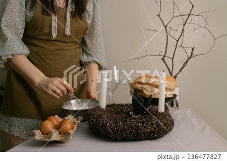Bright Easter day, making festive Easter cake and homemade treats in a warm and cheerful home atmosphere. Bright Easter day, making festive Easter cake and homemade treats in a warm and cheerful home atmosphere. 136477827