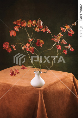 Autumn maple branches in a vase on the table 136479062
