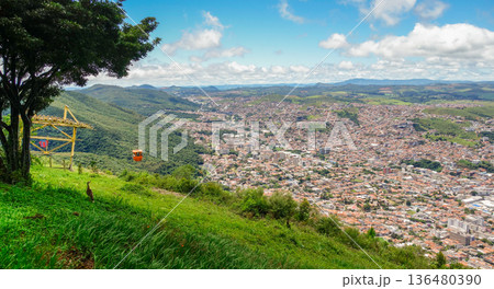 Panoramic view over city of Pocos de Caldas, Minas Gerais, Brazil, and cable car gondola descending towards city Panoramic view over city of Pocos de Caldas, Minas Gerais, Brazil, and cable car gondola descending towards city 136480390