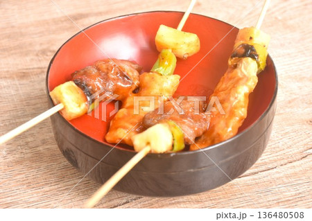 grilled pork and beef meat with pineapple chili dressing barbecue sauce stabbing wooden stick on cup 136480508