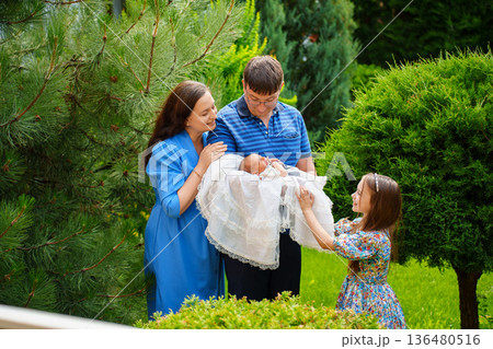 Family gathers for baby presentation in garden Family gathers for baby presentation in garden 136480516