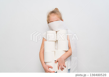 Child plays with toilet paper rolls in a clean indoor space Child plays with toilet paper rolls in a clean indoor space 136480520