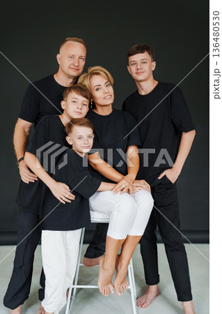 Five family members gather for a portrait in a studio setting Five family members gather for a portrait in a studio setting 136480530