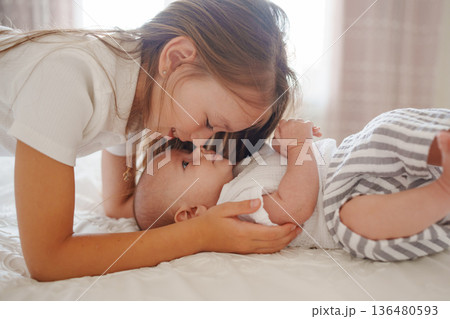 Sister bonding with her baby brother at home 136480593