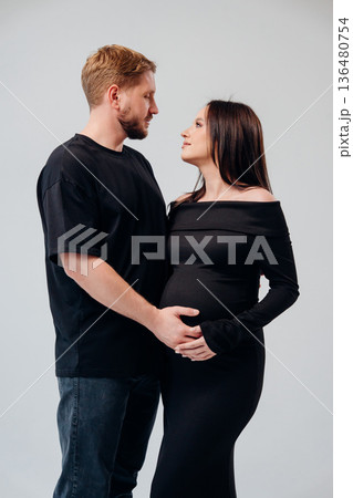 Expecting parents share a loving moment together 136480754