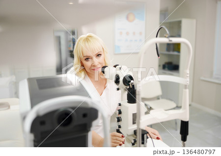 Ophthalmologist examining a patient in a clinic setting 136480797