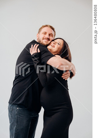 Couple joyfully embracing before welcoming new baby Couple joyfully embracing before welcoming new baby 136480808