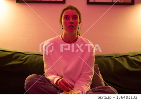 Drawn Into the Screen Under Soft Pink Lighting 136481132