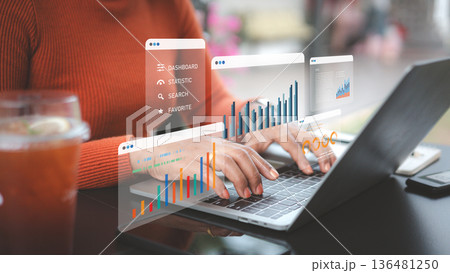 Business data analytics concept with professional user working on laptop with virtual dashboard of financial charts and growth statistics. 136481250