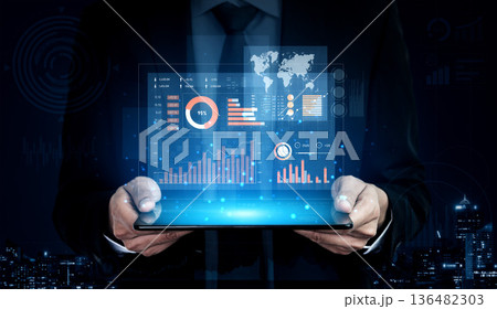 Businessman in Suit Holding Digital Tablet with Graphs, Charts and World Map Displaying Financial Data Against a Night City Skyline Background Scalp Businessman in Suit Holding Digital Tablet with Graphs, Charts and World Map Displaying Financial Data Against a Night City Skyline Background Scalp 136482303