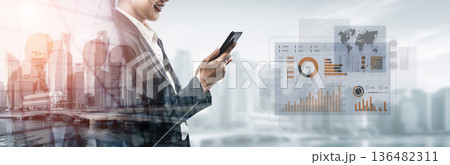 Business professional using smartphone with data analytics graphics, urban skyline and financial charts symbolizing modern technology in the workplace Scalp 136482311