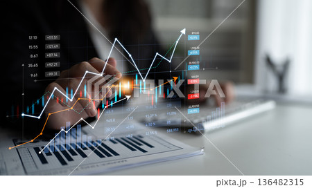 Business professional analyzing data charts and financial graphs on a modern office desk, symbolizing growth and success in investment strategy Scalp Business professional analyzing data charts and financial graphs on a modern office desk, symbolizing growth and success in investment strategy Scalp 136482315