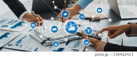 Hands of Business Professionals Analyzing Data and Statistics with Calculator and Graphs in a Modern Office Environment. Amity Hands of Business Professionals Analyzing Data and Statistics with Calculator and Graphs in a Modern Office Environment. Amity 136482421