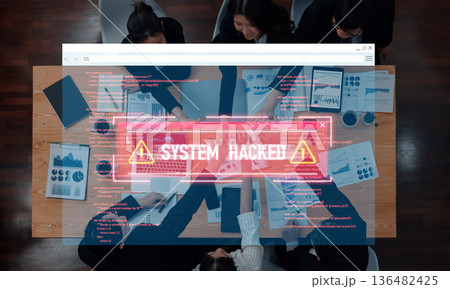 High Angle View of Business Team Collaborating Over Table with Data Analysis and Alert Notification of System Hack Displayed on Screen Trope High Angle View of Business Team Collaborating Over Table with Data Analysis and Alert Notification of System Hack Displayed on Screen Trope 136482425