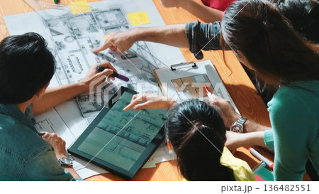 Top view of engineer team writing at blueprint and planning design. Symposium. 136482551