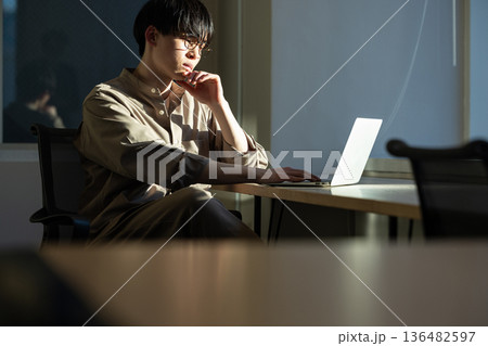 窓際で仕事をする男性 136482597