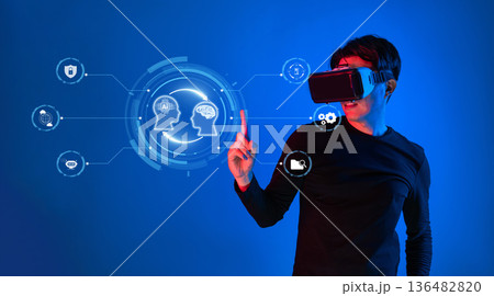 A Person Using Virtual Reality Headset Engaging with AI-Driven Icons in Futuristic Digital Environment XDMCP A Person Using Virtual Reality Headset Engaging with AI-Driven Icons in Futuristic Digital Environment XDMCP 136482820