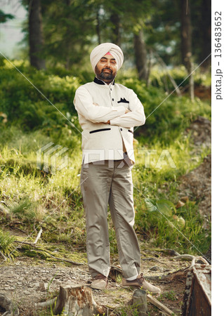 Indian man in a mountains. Male in a traditional turban. Hinduist. 136483652