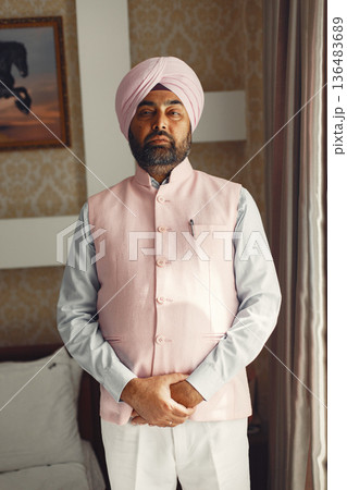 Indian man in a room. Male in a traditional turban. Hinduist in a room. 136483689