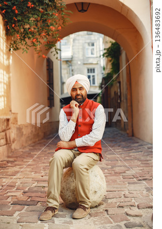 Indian man in a city. Male in a traditional turban. Hinduist in a summer city. Indian man in a city. Male in a traditional turban. Hinduist in a summer city. 136483692