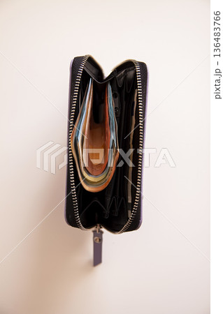 A wallet filled with euro banknotes on a table. Spending power and financial confidence. A wallet filled with euro banknotes on a table. Spending power and financial confidence. 136483766