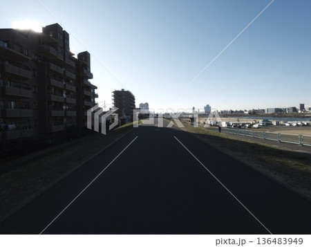 冬の晴天に続く多摩川の堤防道路と街並みの風景 冬の晴天に続く多摩川の堤防道路と街並みの風景 136483949