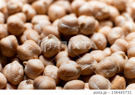 Close-up macro of raw chickpea kernels in a clear storage jar Close-up macro of raw chickpea kernels in a clear storage jar 136485732