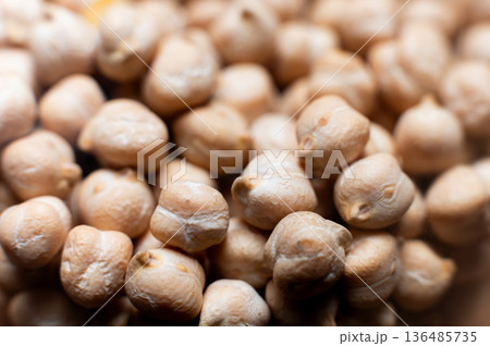 Close-up macro of raw chickpea kernels in a clear storage jar Close-up macro of raw chickpea kernels in a clear storage jar 136485735