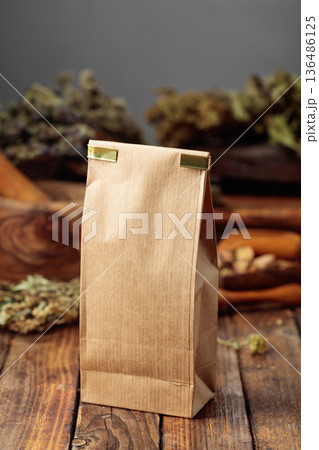 Tall brown paper bag on an old wooden table. 136486125