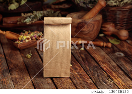 Tall brown paper bag on an old wooden table. 136486126