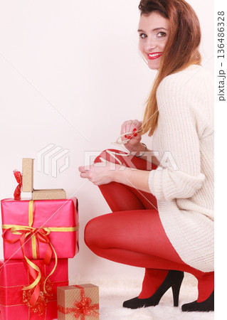 Woman with many christmas gift boxes Woman with many christmas gift boxes 136486328