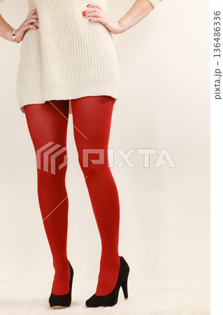 woman legs in red vivid color pantyhose black high heels shoes 136486336